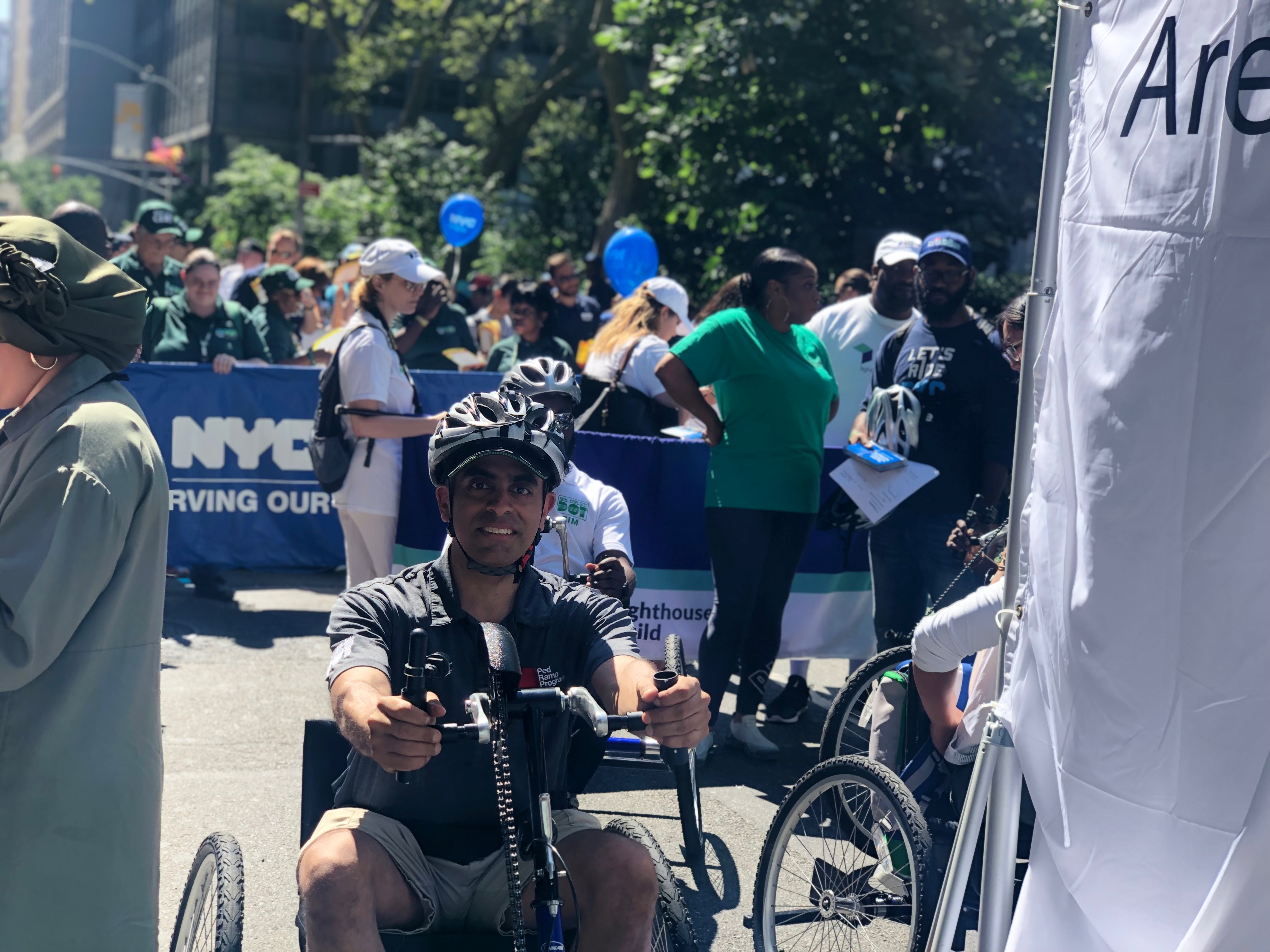 A young athlete in hand bike at fifth annual disability pride parade, New York.