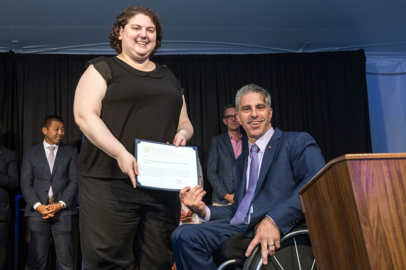Image of Jill Rothstein, Chief Librarian accepting Communications and Technology Award on behalf of Andrew Heiskell Braille and Talking Book Library 