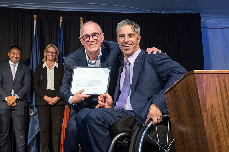 Image of Frieda Zames Advocacy Award winner Rick Surpin hugging Commissioner Victor Calise 